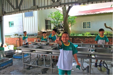 Kids washing their own dishes after lunch in an elementary school in Tainan